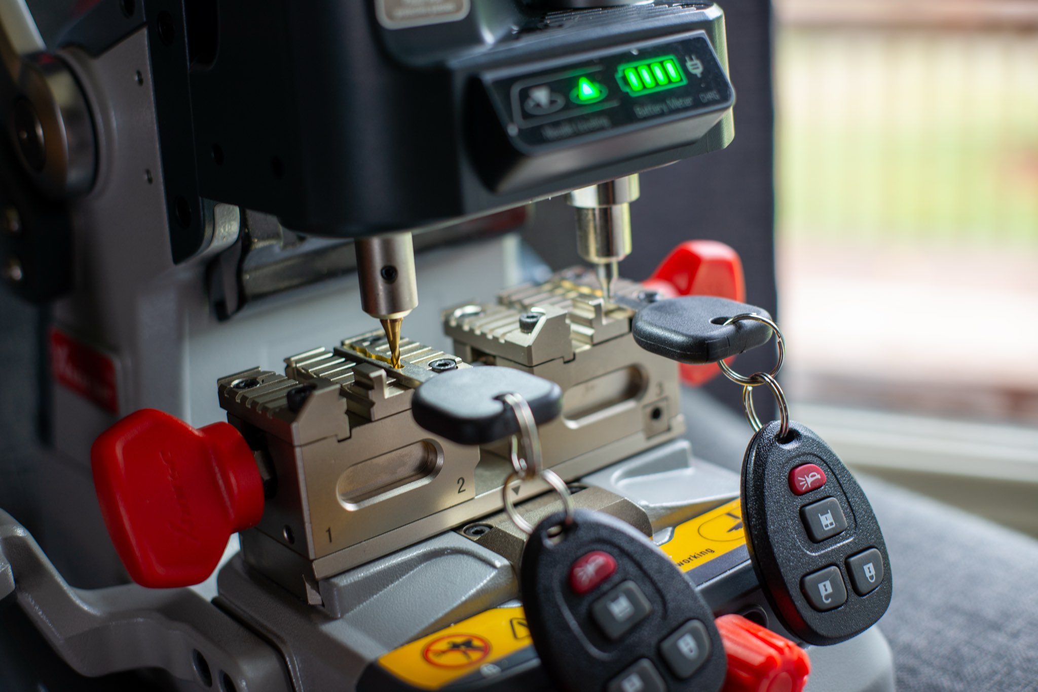 Key duplication machine with automotive keys and key fobs.